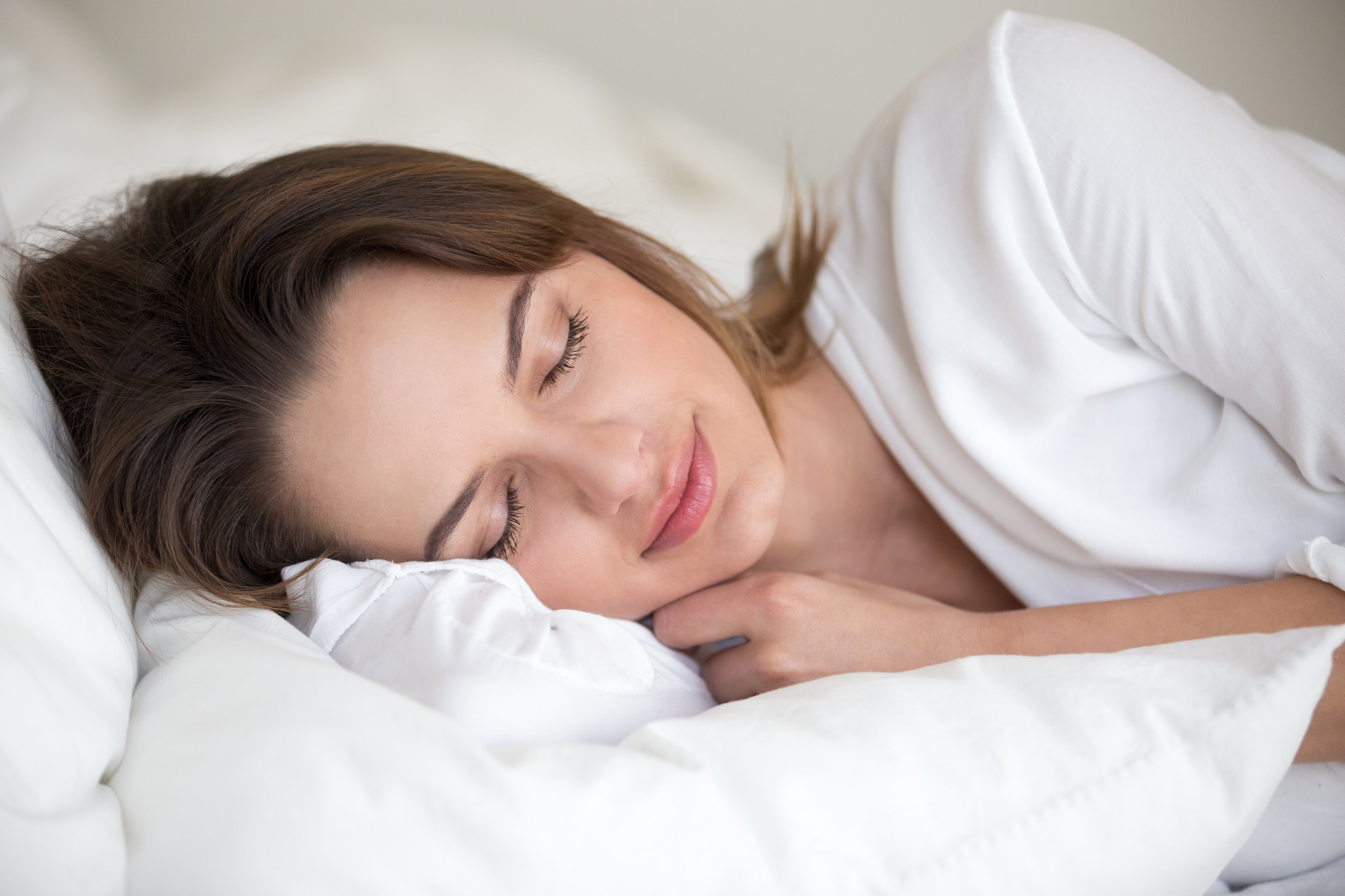 woman sleeping white linen